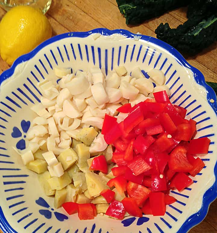 Chop peppers, artichokes, and hearts of palm into small pieces about 1/2 inch square although don't get too fussy about it.