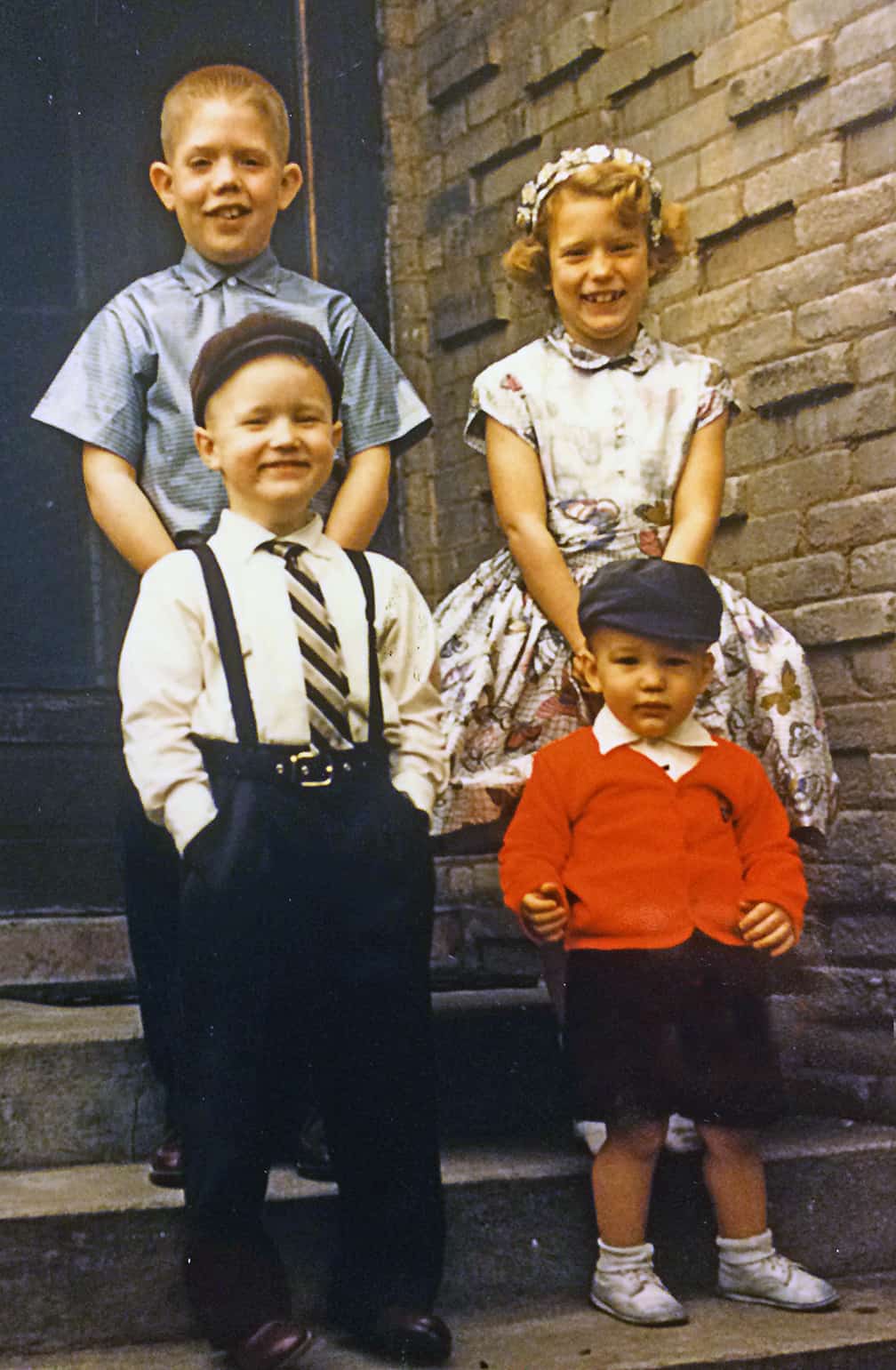 This photo was taken on an Easter Sunday when my family lived in Muncie, Indiana. My older brother Steve was on my side, and Chuck (in suspenders) and Phil (red jacket) were below. My brother Rich was an infant and in my mother's arms when this photo was taken. 