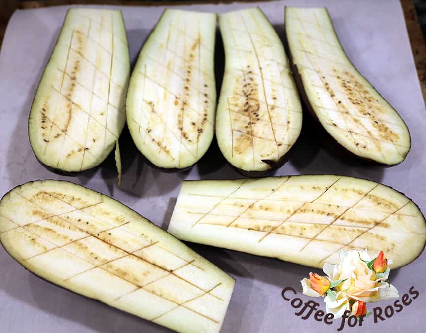 Score the eggplant with a knife but don't cut through the skin. This will help the eggplant to bake more quickly and will let the sauce drip down inside.