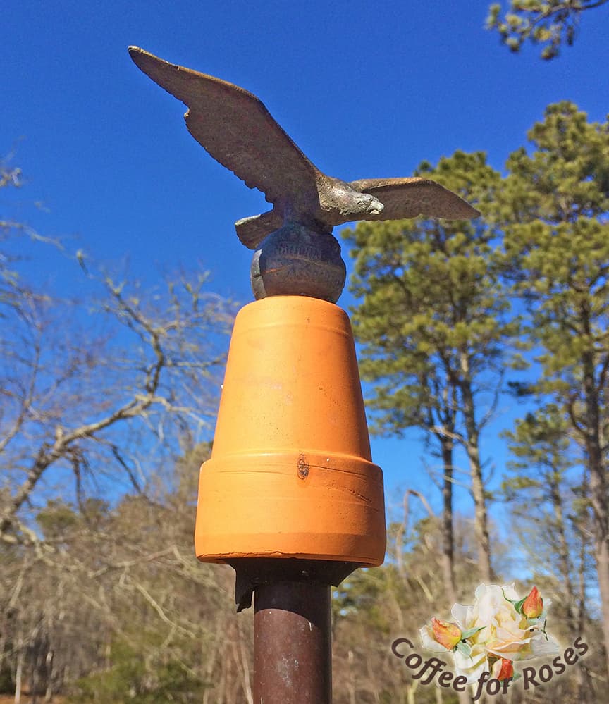The top piece is a flower pot topped by a metal flag pole topper I found in a thrift store. All the small birds perch on this eagle on their way down to the feeder.