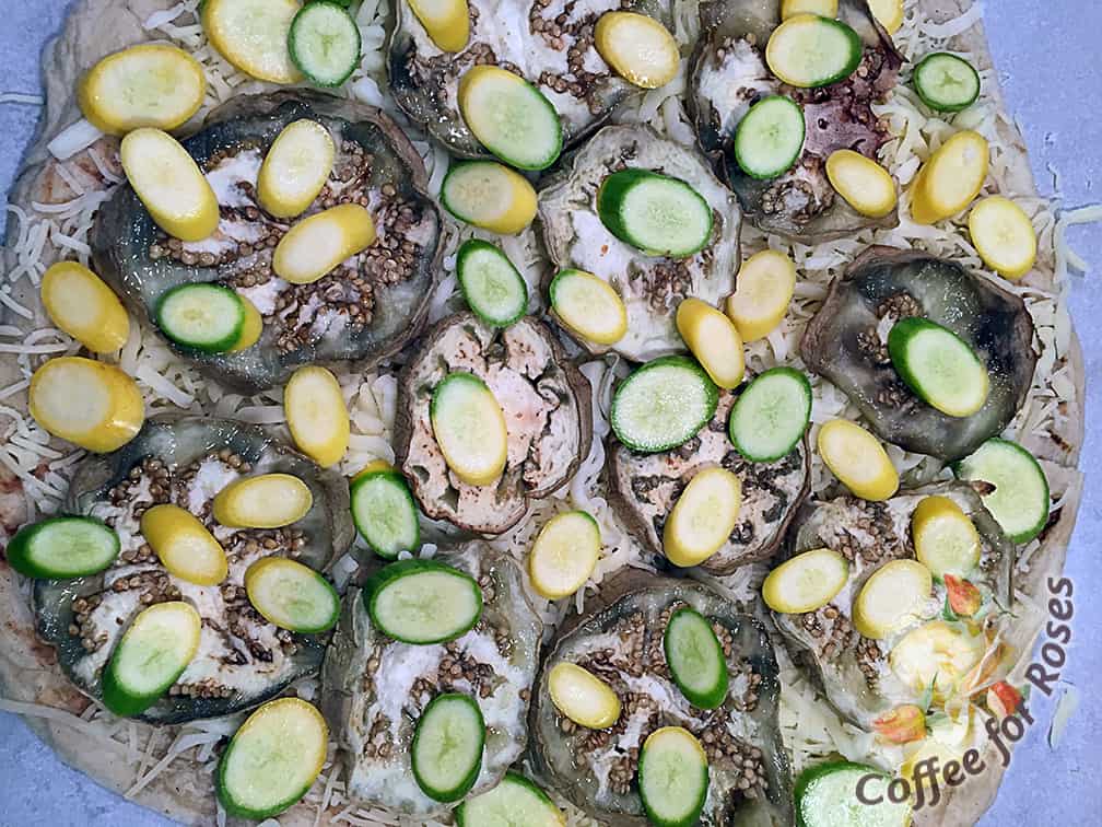 I placed roasted eggplant all over the cheese topped crust and then added sliced summer squash pieces.