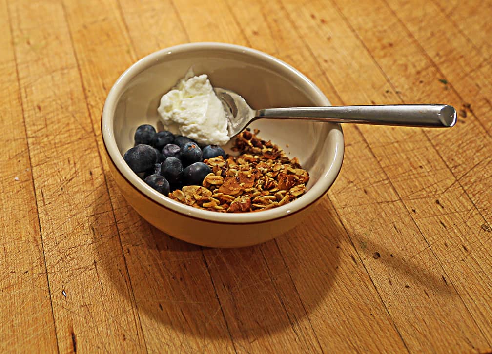 Once the granola is done let it cool before packing it in plastic bags until it's time to eat it. We love this granola with fat-free Greek yogurt and berries. 
