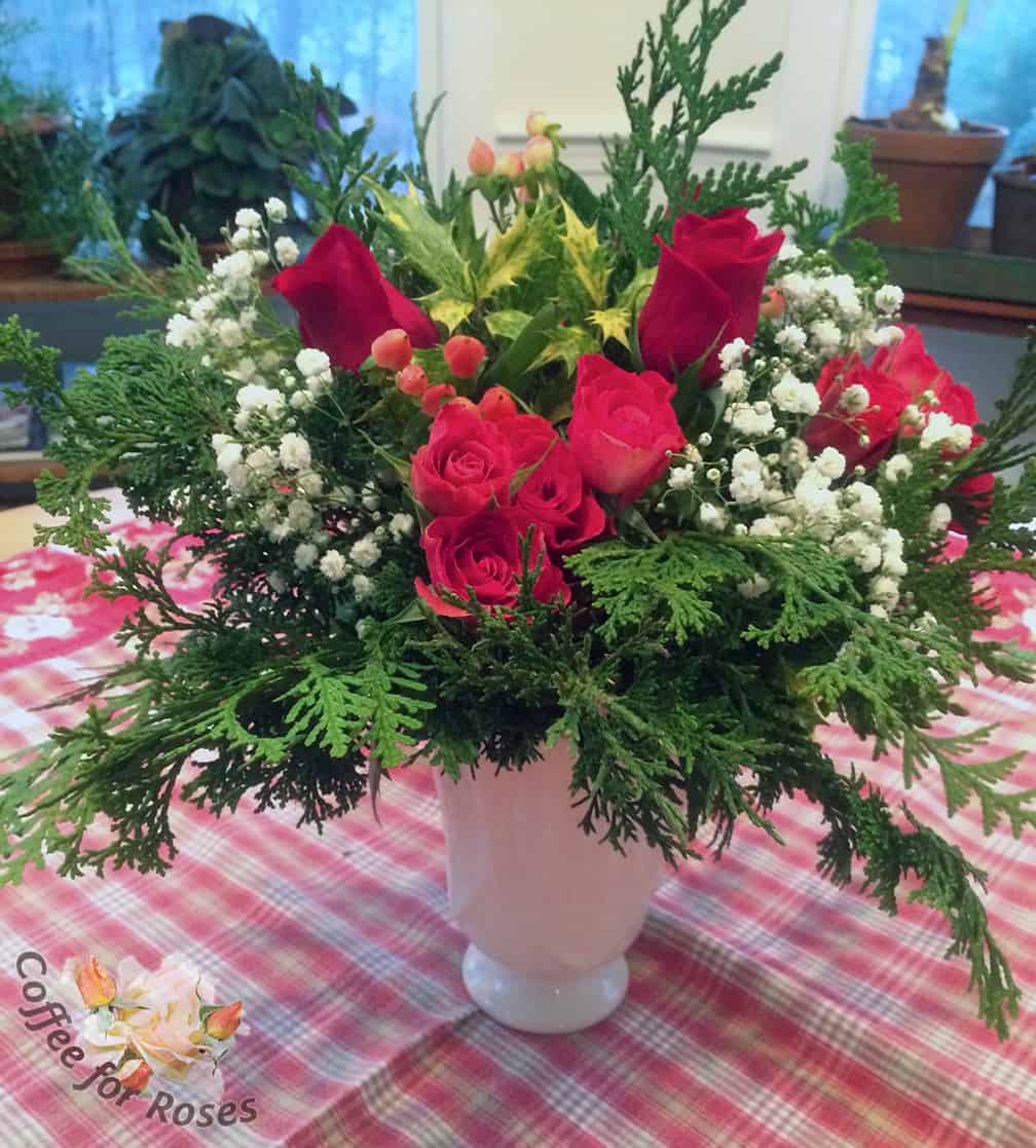 I used the the baby's breath that came with the red roses in this arrangement because the white of those flowers echoes the white color of the vase.