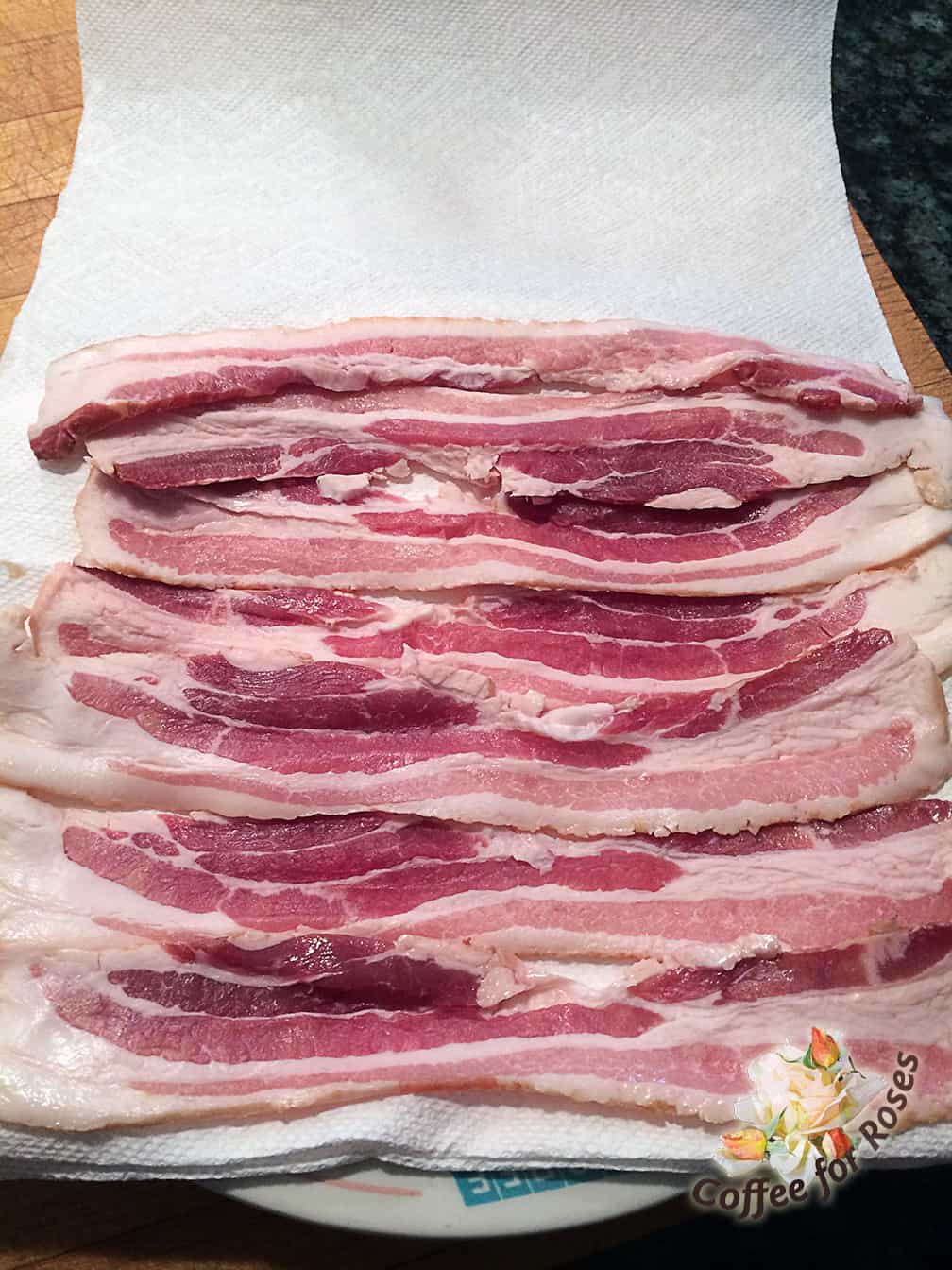 I cook my bacon in the microwave so that it doesn't smell up the entire house with bacon fumes. I put three or four layers of paper towel down on a plate leaving a piece of paper towel large enough to fold over the bacon after it's on the place. I line up the bacon closely on that plate and cover with one layer of paper towel to prevent splatter in the microwave. Cook on high for four minutes and then check it - some microwaves will need another one or two minutes to cook the bacon crispy. If the pieces are more done on the edges, either shuffle them around or take out the finished strips and cook the others a bit longer.