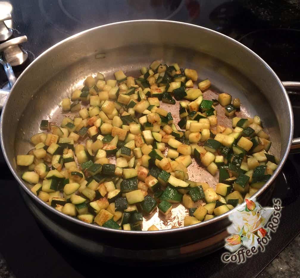 Chop the zucchini into small cubes. Put the tablespoon of olive oil in the pan and saute the squash over medium heat until it browns and begins to soften.