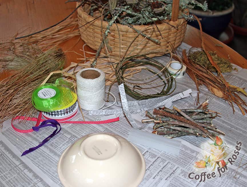 You need a small bowl, assorted twigs, a glue gun, moss or lichen, and assorted dried grasses, bark, ribbons, papers, pine needles or other nesting materials that strike your fancy.