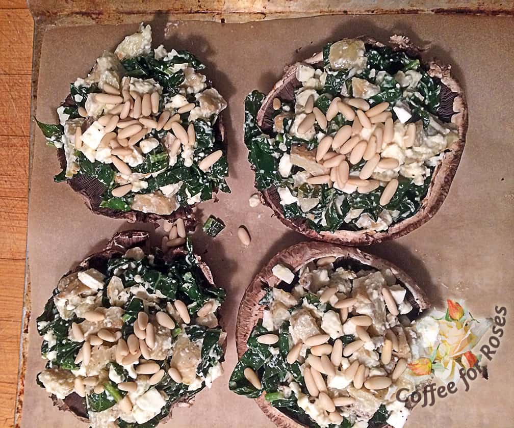 Mix the recently cooked kale with all the other ingredients and pile them on top of the mushroom. Sprinkle the top with pine nuts. Bread crumbs mixed with a little butter or olive oil would be a good topping too.