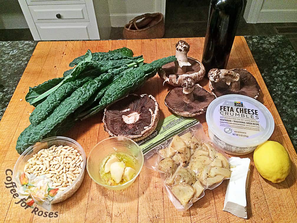 I used Tuscan Kale from the garden, roasted garlic (you could use raw), Portabella mushroom caps, pine nuts, feta cheese, a piece of ricotta salata, grilled artichokes in a package (you could use canned) and a lemon. 