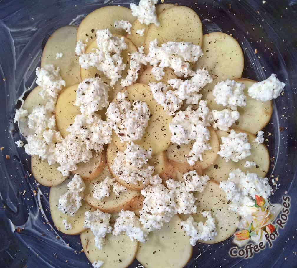 I sliced the potatoes thinly and arranged a layer in a buttered oven proof bowl. Next I put on a layer of ricotta cheese and some pepper. 