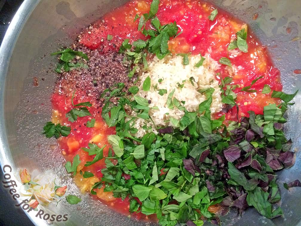 Chop the basil and parsley, and add to the mashed tomato insides along with the rice. Stir well.