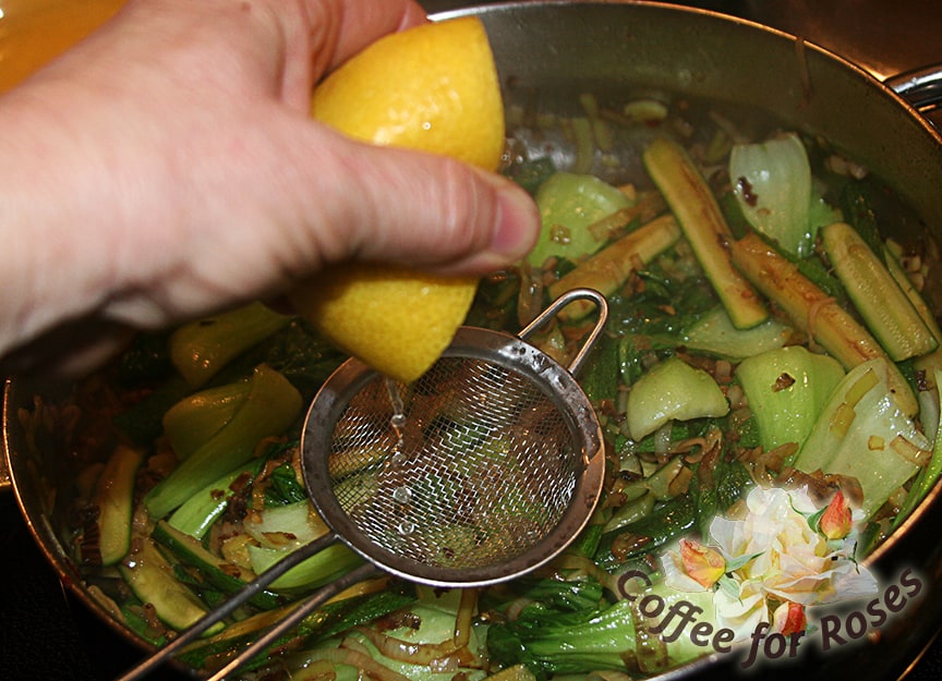 Uncover and bring heat up to medium again. Squeeze the lemon over veggies catching seeds in a strainer. Stir well.