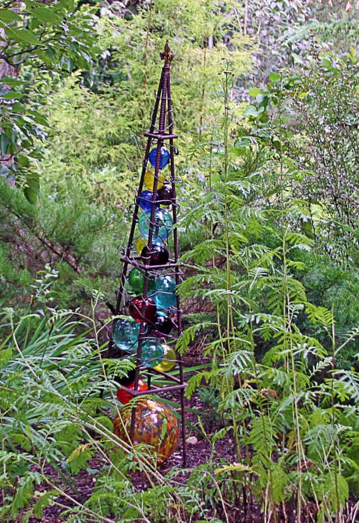 This totem was created out of a garden obelisk that was filled with glass balls.