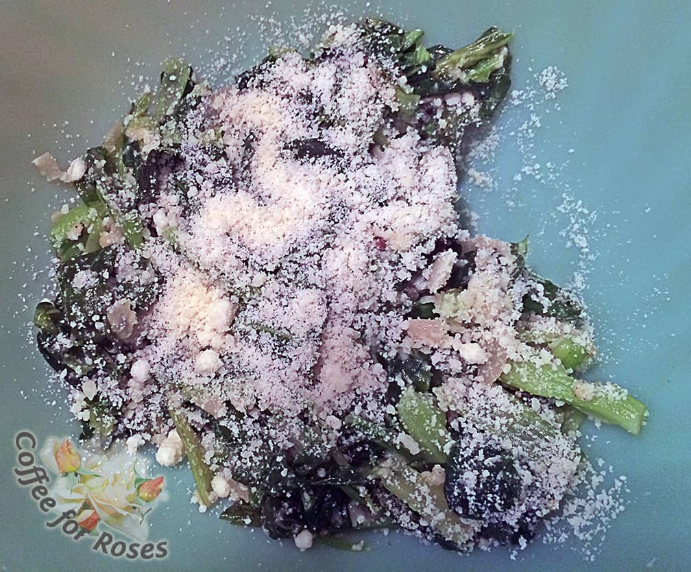 Once the greens are fully wilted and tender, place them in a bowl and spinkle with the cheese.