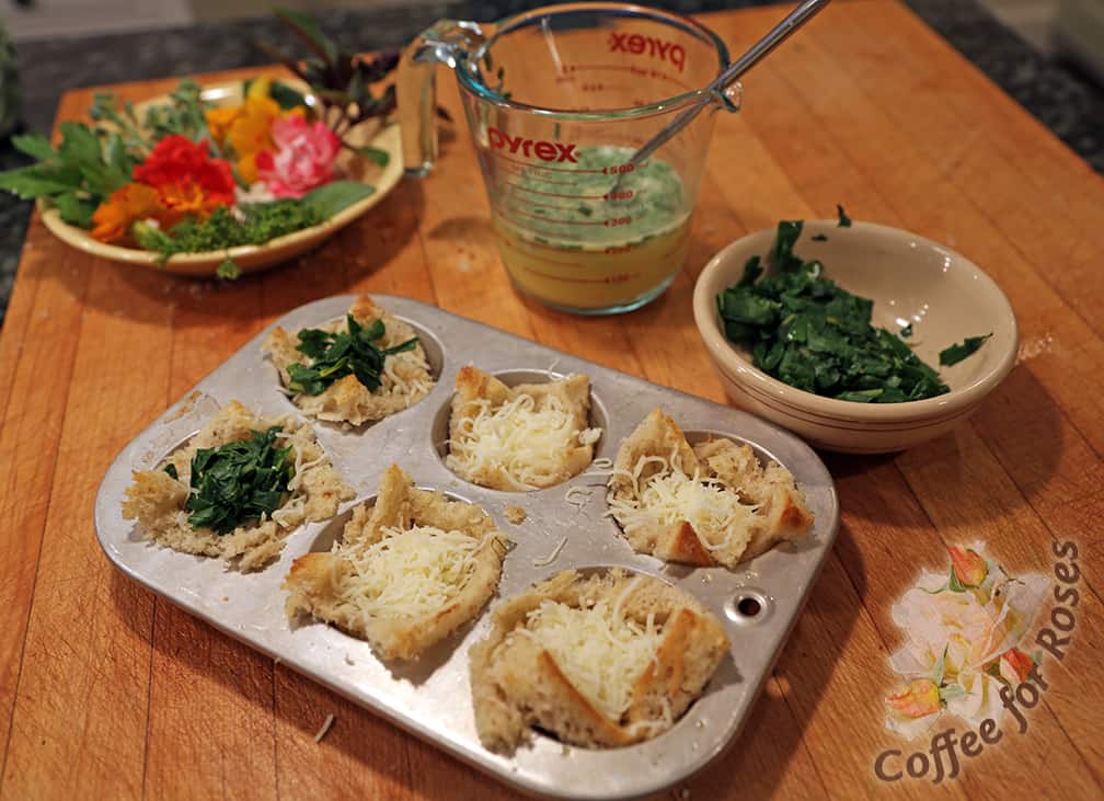 Remove the pre-baked bread from the oven and first put some cheese in each tart. On top of the cheese add the veggie you're using. I used chard that was steamed for four minutes to wilt it. You might want to steam or saute squash, broccoli or other veggies before adding them to the tarts as well.