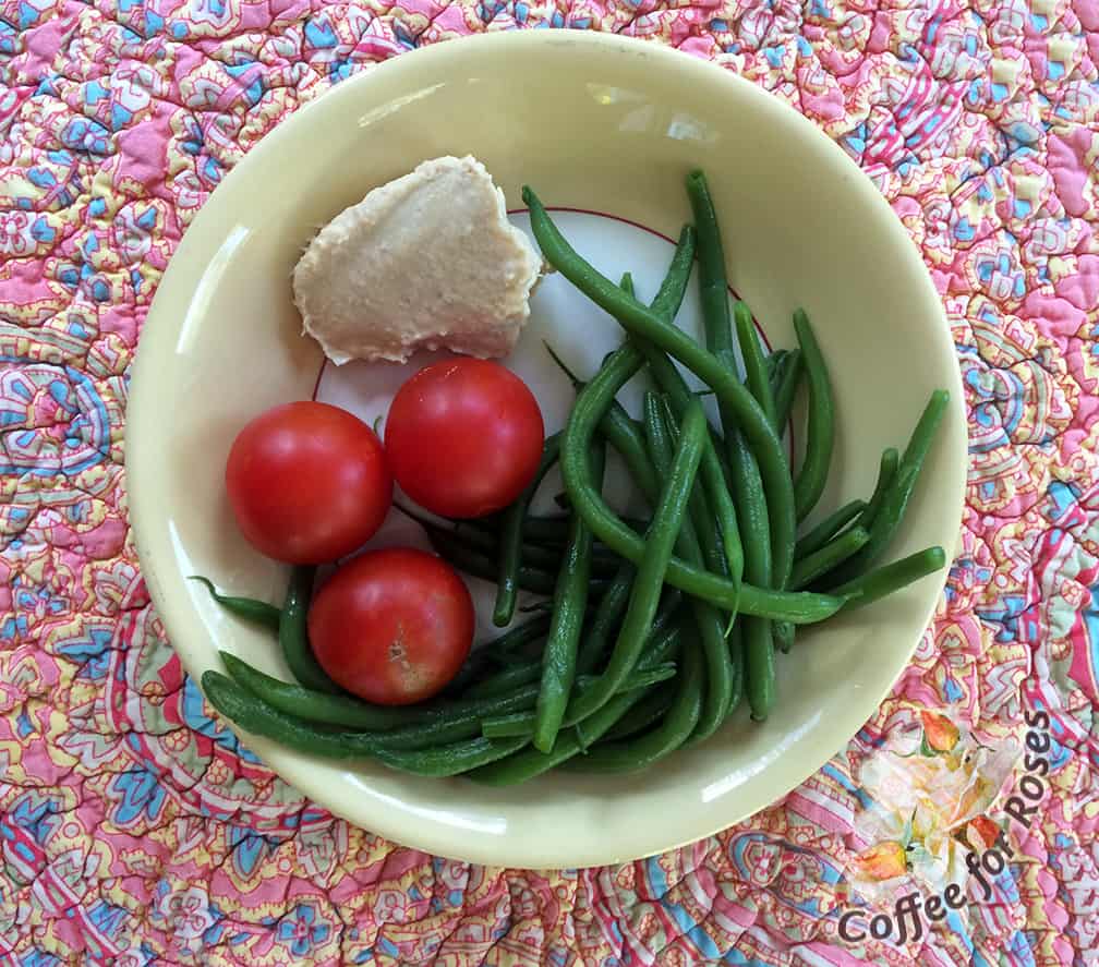 Steamed green beans, about 50 calories. Three large cherry tomatoes, about 15. Two tablespoons of hummus for dipping, 70 calories. So for less than 150 calories you have a flavorful, statisfying snack or lunch. Emphasis on the word flavorful.