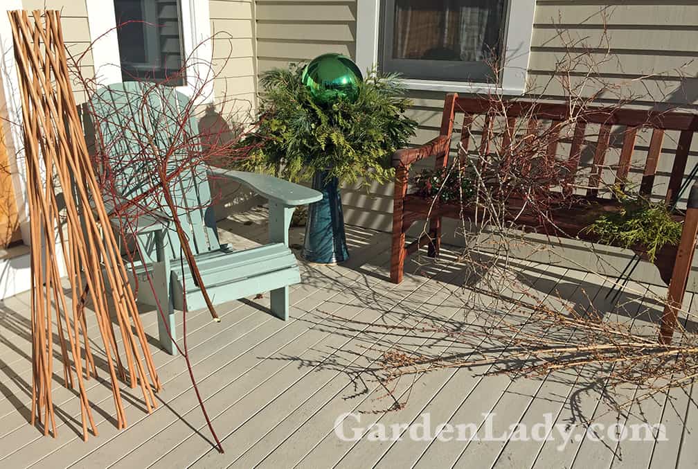 Here are the supplies, grouped around the birdbath that still has the holiday topper in place. I put the globe away and threw out the old greens. 