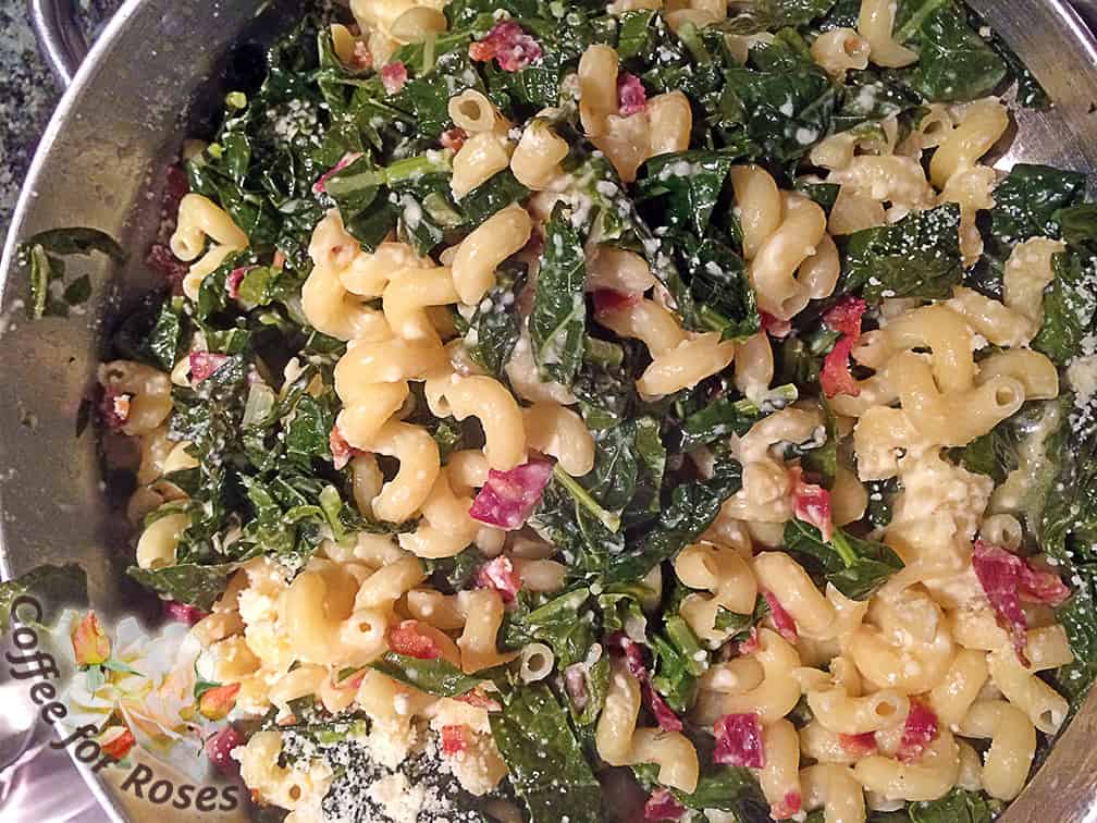 Toss the pasta in with the chard/kale/garlic mixture. Add the bacon and the cheese and toss again. Serve and enjoy! 