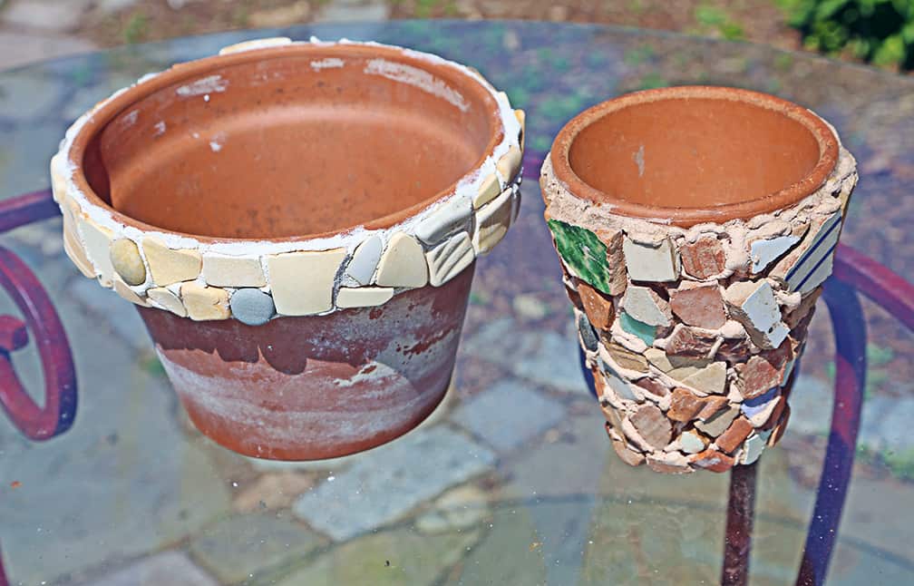 The pot on the right was created after a trip to Italy. As we walked I picked up random rocks and old pieces of tiles that I found on the roads. Every day I collected a few small treasures, and by the end of our trip I had a small plastic bag with assorted rocks and shards. I tinted the grout/adhesive mix so that it became a pale terracotta color, and filled the entire pot with my collection. This pot holds pairs of scissors on my kitchen counter.