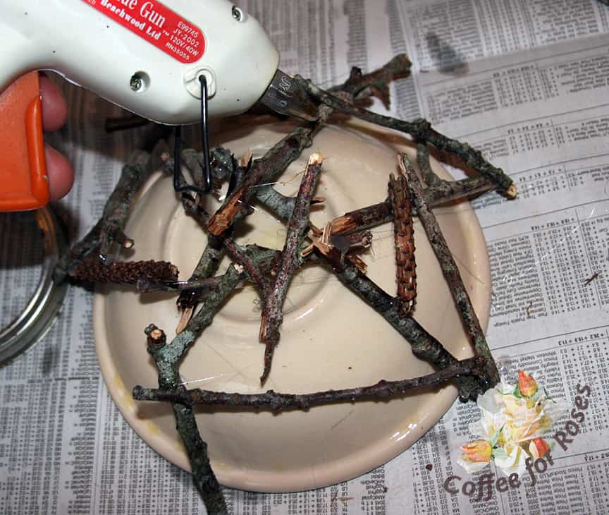 Continue to randomly position sticks and glue into place with small dabs of hot glue. Once the bowl is removed these twigs will provide the framework for the rest of the materials.