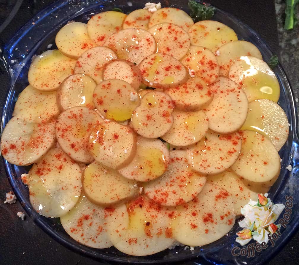 The top layer was potato slices, with some olive oil drizzled over the top and some paprika sprinkled on for color.  I put a top on this dish and baked it at 350 degrees for 30 minutes, removed the cover and baked it for 15 more minutes.