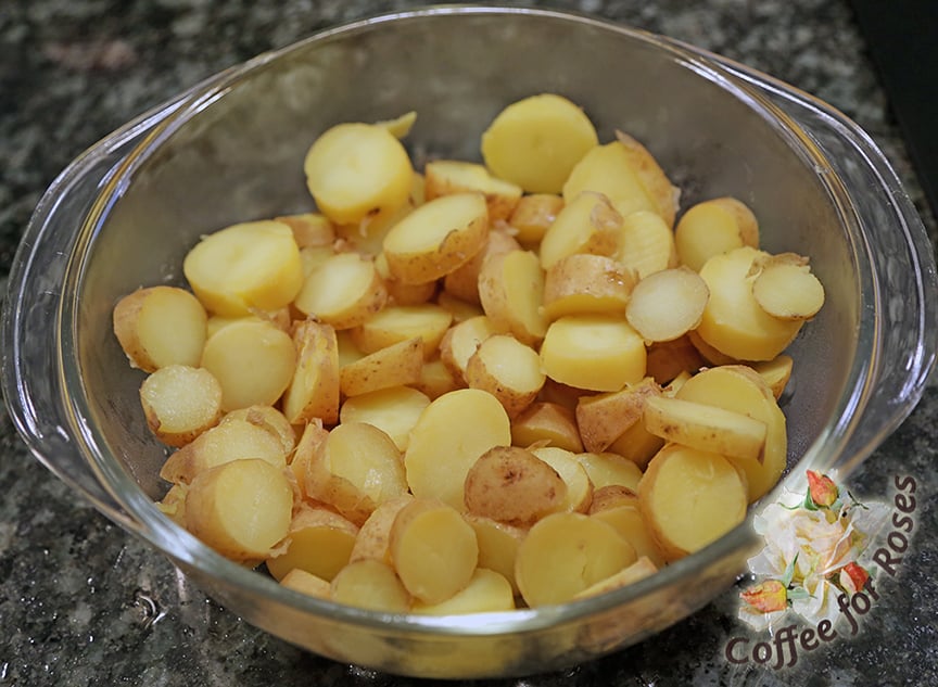 Steam the potatoes and hard boil the eggs. New potatoes don't have to be peeled. After the potatoes are done, slice them into bite size pieces and let them cool while you peel the hard boiled eggs and prepare the other ingredients