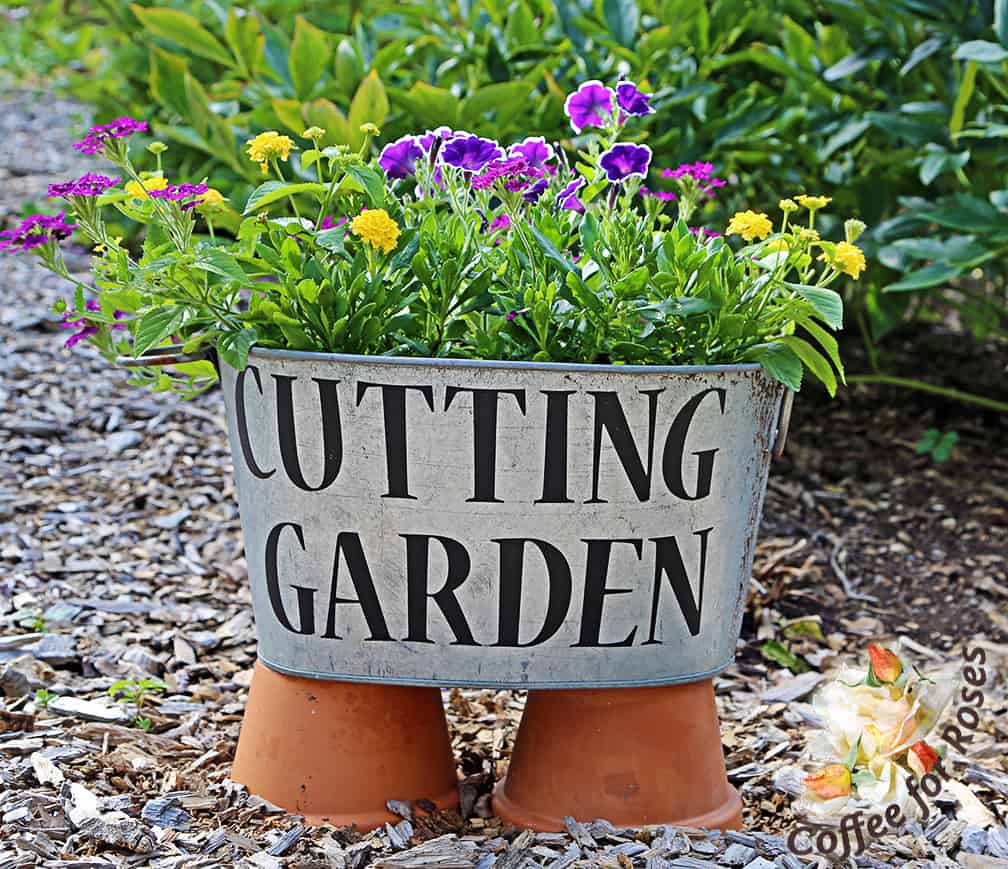 I love the look of galvanized metal in the garden, so in this area I used several old containers that function as planters and signs.