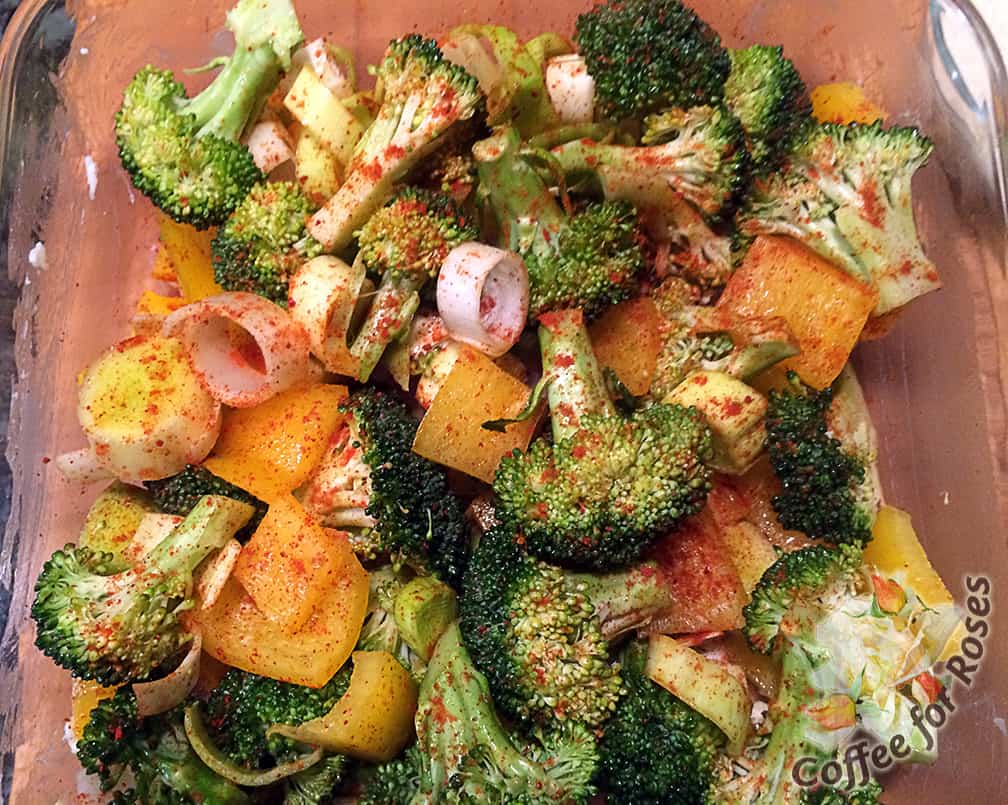 Put the veggies in the greased pan and sprinkle with half of the smoked paprika. 