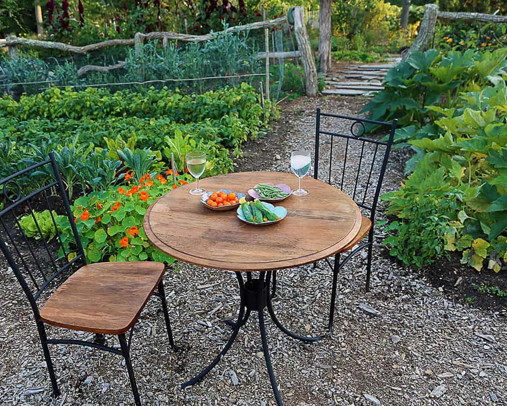 Put a table and chairs in the center of your vegetable garden and toast to how everything is connected to everything else. Cheers!